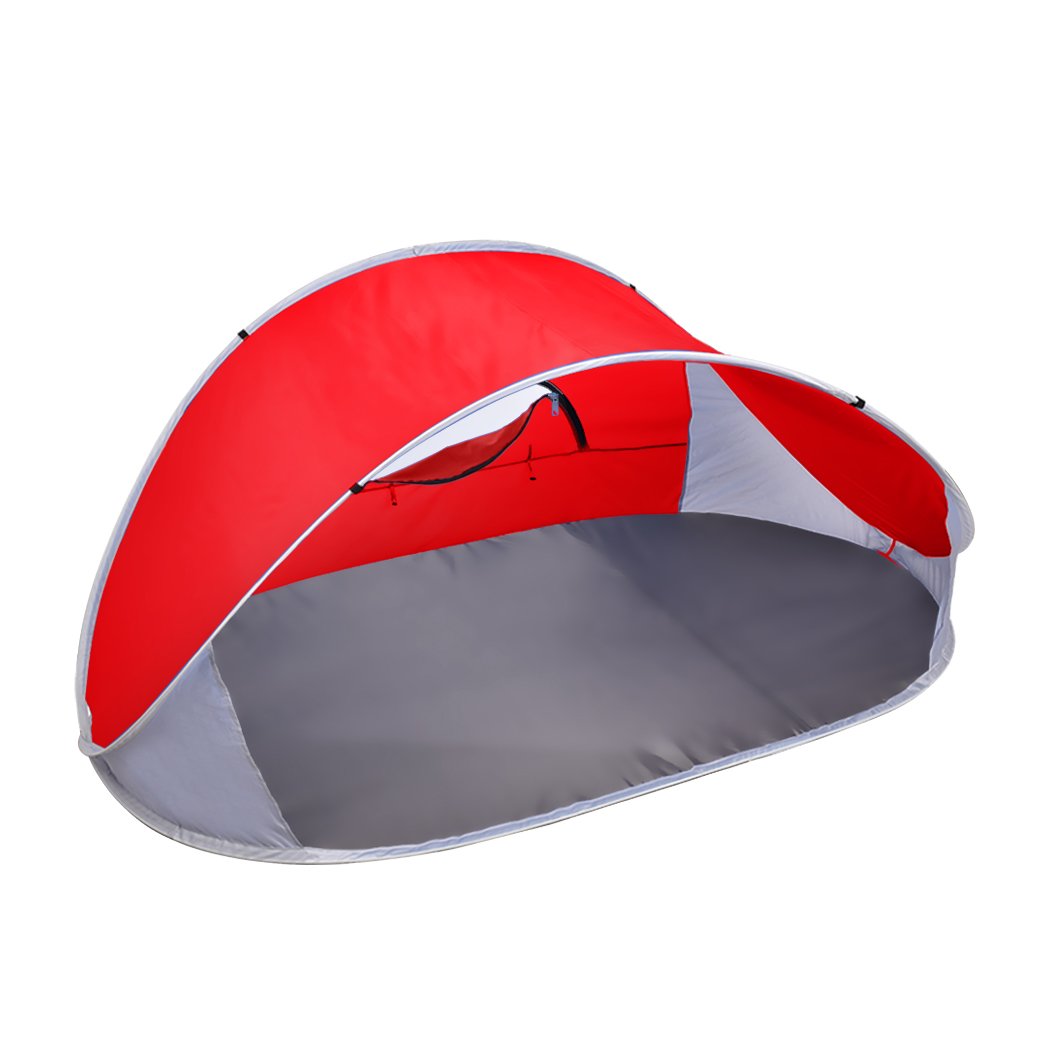 Mountvie Pop Up Tent in red color, spacious enough for 4 people, set up on a beach with a carry bag beside it.